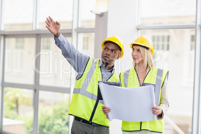 Architects discussing over blueprint