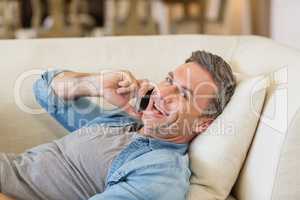 Man talking on mobile phone in living room