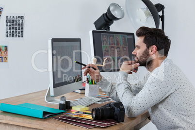 Photographer working on desktop pc