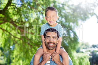 Father carrying son on his shoulders