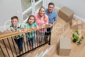 Parents and kids standing in staircase at home