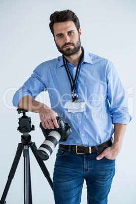 Portrait of male photographer showing identity card