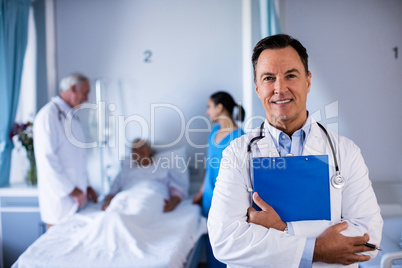 Portrait of male doctor holding medical report