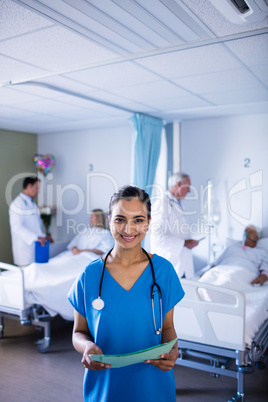 Female doctor smiling while holding a file
