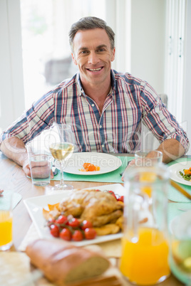 Happy man having meal on dinning table