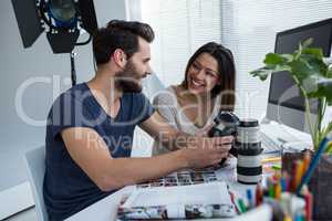 Photographers reviewing captured photos in his digital camera