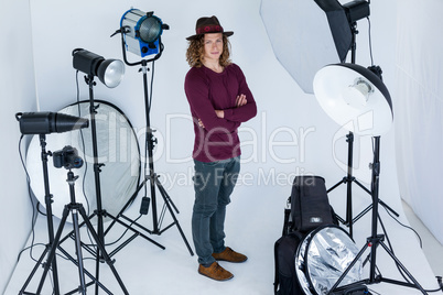 Photographer with hands crossed standing in the photo studio