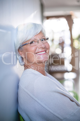 Portrait of senior woman sitting on sofa