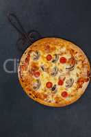Delicious italian pizza served on pizza tray on grey background