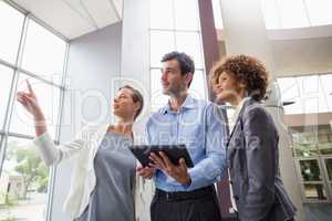 Business executives discussing over digital tablet