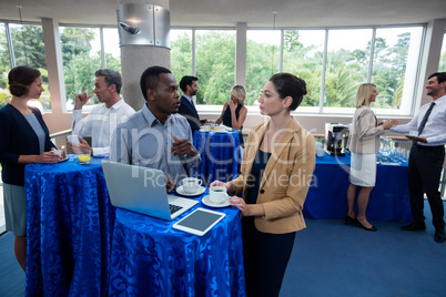 Business executives interacting with each other during break