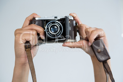 Close-up of female photographer holding old fashioned camera
