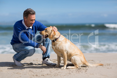 Mature man with his dog on the beach