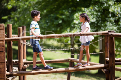 Kids walking on a playground ride in park