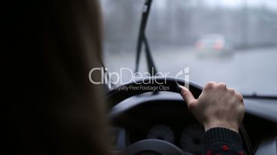 Woman holding steering wheel firmly with hand