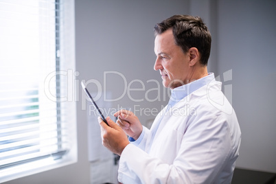 Male doctor using digital tablet