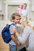 Woman kissing his son while going to school