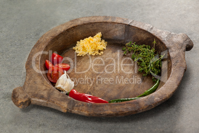 Spices and vegetable in wooden bowl