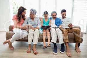Multi-generation family using digital tablet in living room