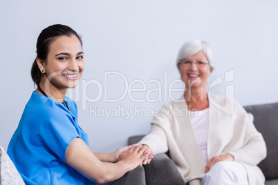 Portrait of doctor consoling senior patient