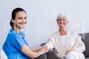 Portrait of doctor consoling senior patient