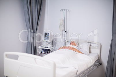 Senior woman patient sleeping on bed