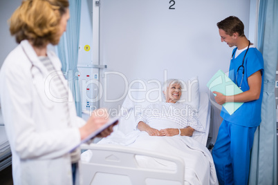 Doctors talking to a senior patient