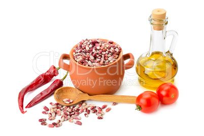 beans in a ceramic pot, cooking oil and vegetables isolated on w