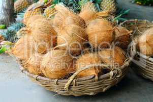 Coconuts in the basket in a vegetable shop