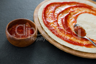 Pizza dough with tomato sauce