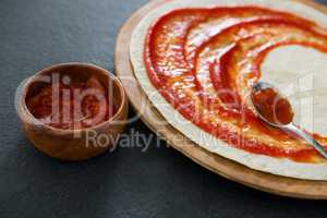 Pizza dough with tomato sauce