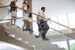 Business executives walking down the stairs