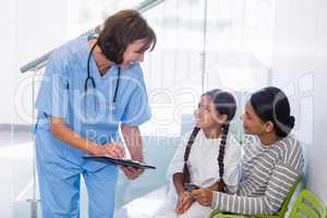 Nurse discussing a medical report with woman and patient