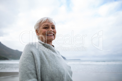 Portrait of senior woman standing on the beach