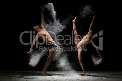 Young couple poses in white dust cloud studio shot