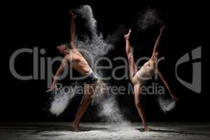 Young couple poses in white dust cloud studio shot