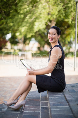 Happy businesswoman holding digital tablet