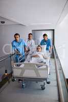 Team of doctors taking a pregnant woman to operation theatre