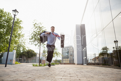 Businessman holding briefcase running