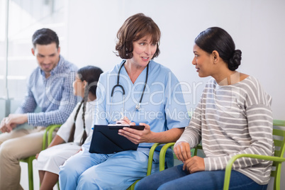 Nurse discussing a medical report with woman