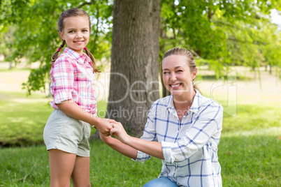 Portrait of a mother embracing her daughter in park