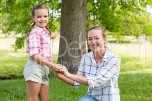 Portrait of a mother embracing her daughter in park