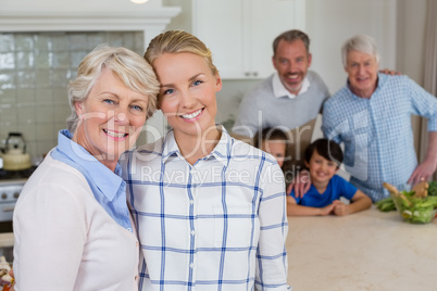 Portrait of happy family standing in kitchen