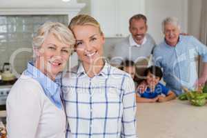 Portrait of happy family standing in kitchen