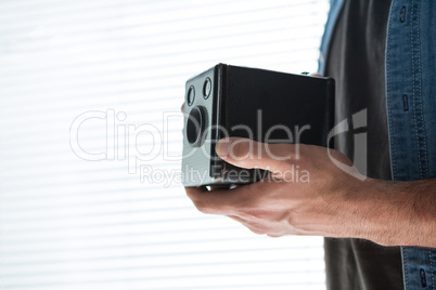 Mid section of male photographer with old fashioned camera