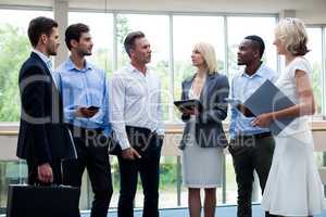 Business executives interacting in a conference center lobby