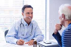 Doctor prescribing medicine to senior patient