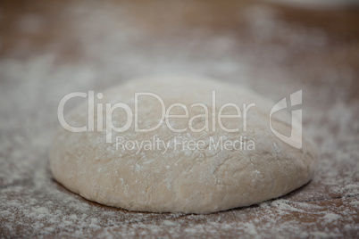 Pizza dough and flour on rolling board