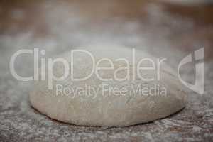 Pizza dough and flour on rolling board