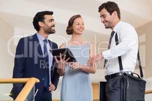 Business executives discussing over digital tablet